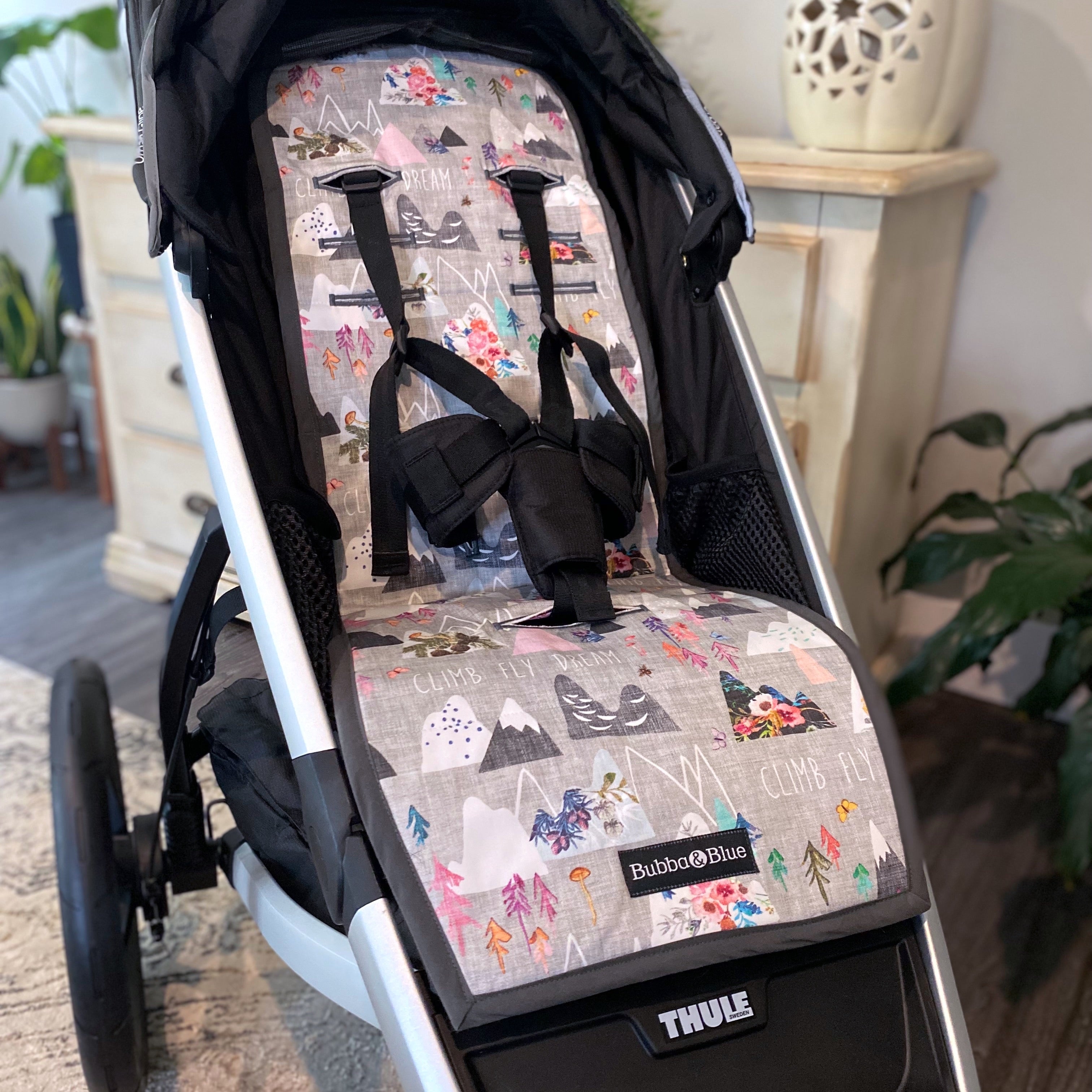 Stroller liner and foormuff set made to fit most strollers. Get a custom fit for a wide variety of strollers. These save your seat from wear and tear. This one is featured in the pink mountain print.