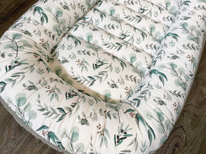 baby nest , baby lounging nest, co-sleeper, similar to dockatot and snuggle me products. This one is featured in a eucalyptus design.