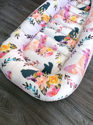 baby nest , baby lounging nest, co-sleeper, similar to dockatot and snuggle me products. This one is featured in a floral bear pink design.