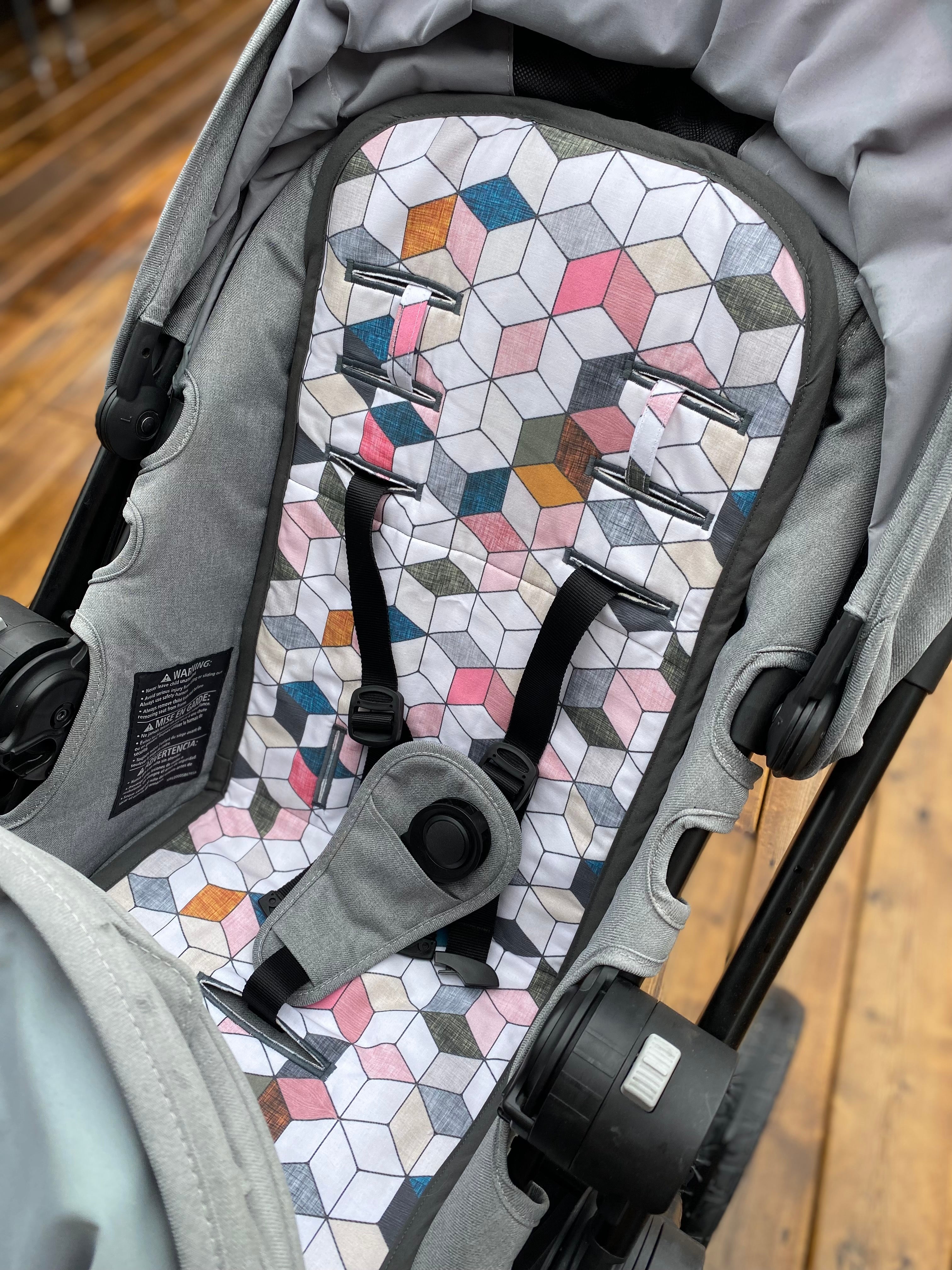 Stroller liner and foormuff set made to fit most strollers. Get a custom fit for a wide variety of strollers. These save your seat from wear and tear. This one is featured in the pink hex print.