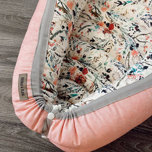 baby nest , baby lounging nest, co-sleeper, similar to dockatot and snuggle me products. This one is featured in a fable floral design.